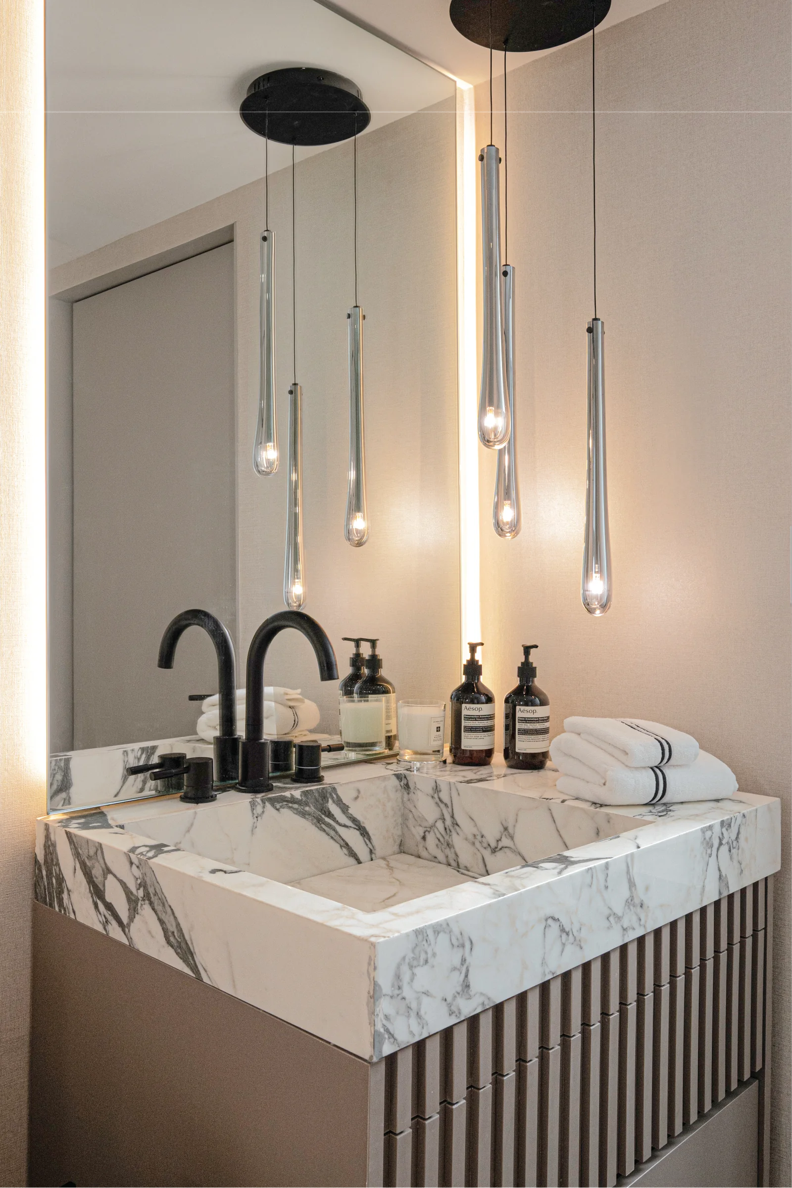 Casa Sienna — Natural stone vanity and warm architectural lighting
